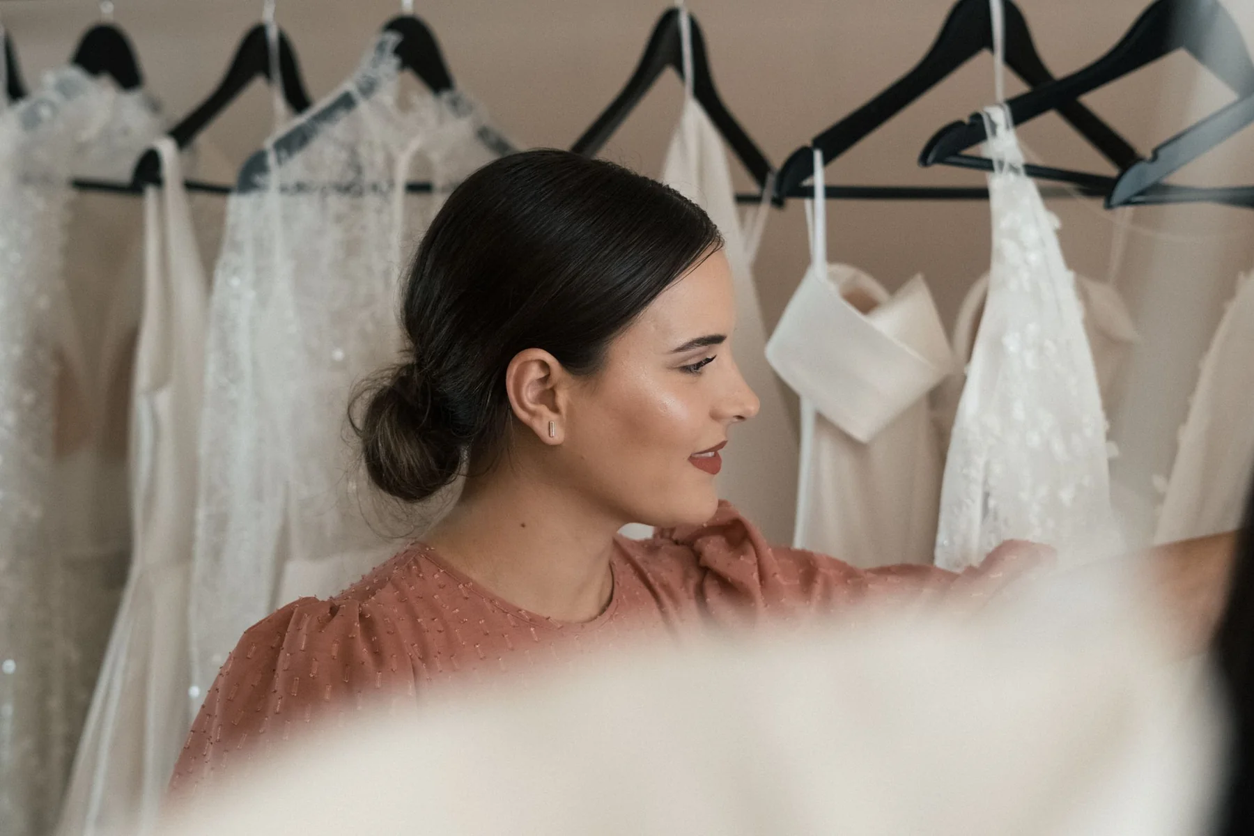 A bride choosing a gown in a bridal boutique