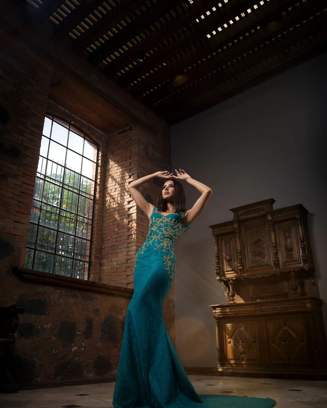 Woman in a blue gown in an ornate interior