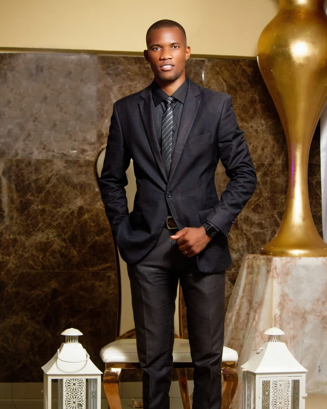 Man in a black suit in an elegant room